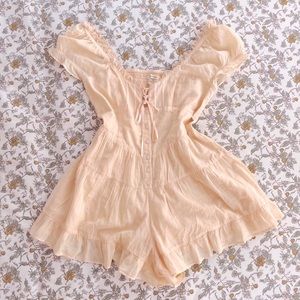 Peach lacy ruffled romper in size small, worn only once.